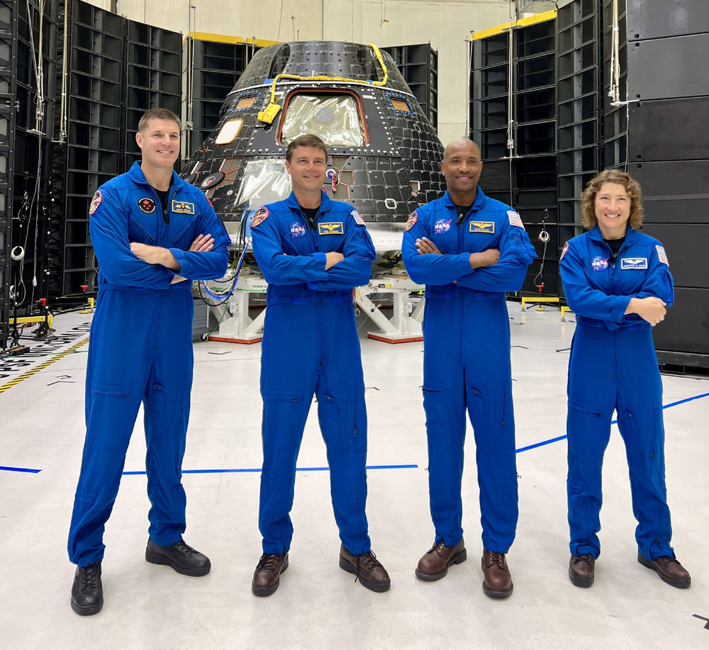 The Artemis 2 crew with their Orion Capsule, (from left to right) Canadian Space Agency Artemis II Mission Specialist Jeremy Hansen, NASA Artemis II Commander Reid Wiseman, NASA Artemis II Pilot Victor Glover, NASA Artemis II Mission Specialist Christina Hammock Koch. ©NASA