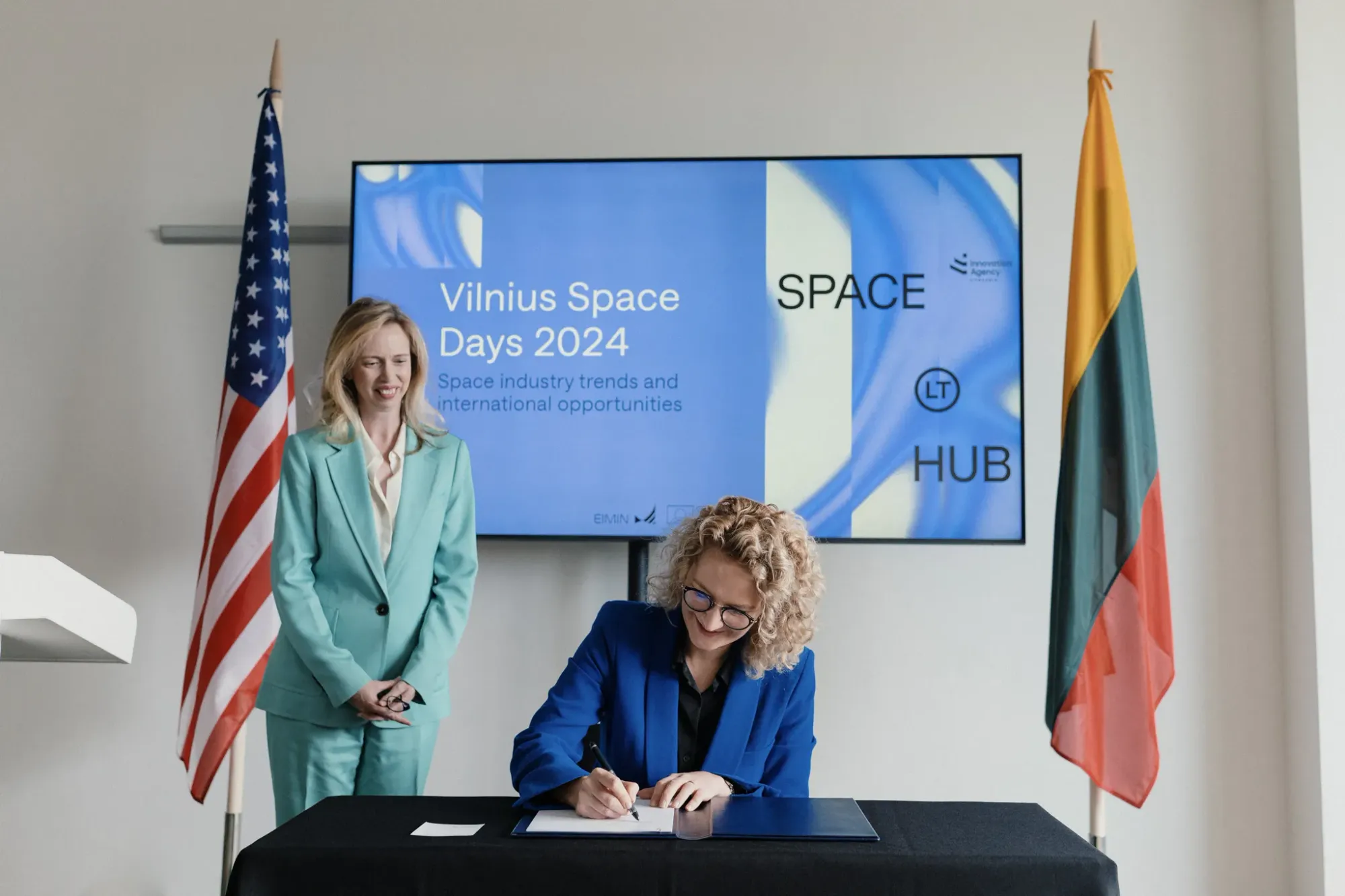 Lithuanian Minister of Economy and Innovation, Aušrinė Armonaitė, (center) signing the Artemis Accords with United States Ambassador, Kara C. McDonald, (left) present. ©Lithuanian Innovation Agency