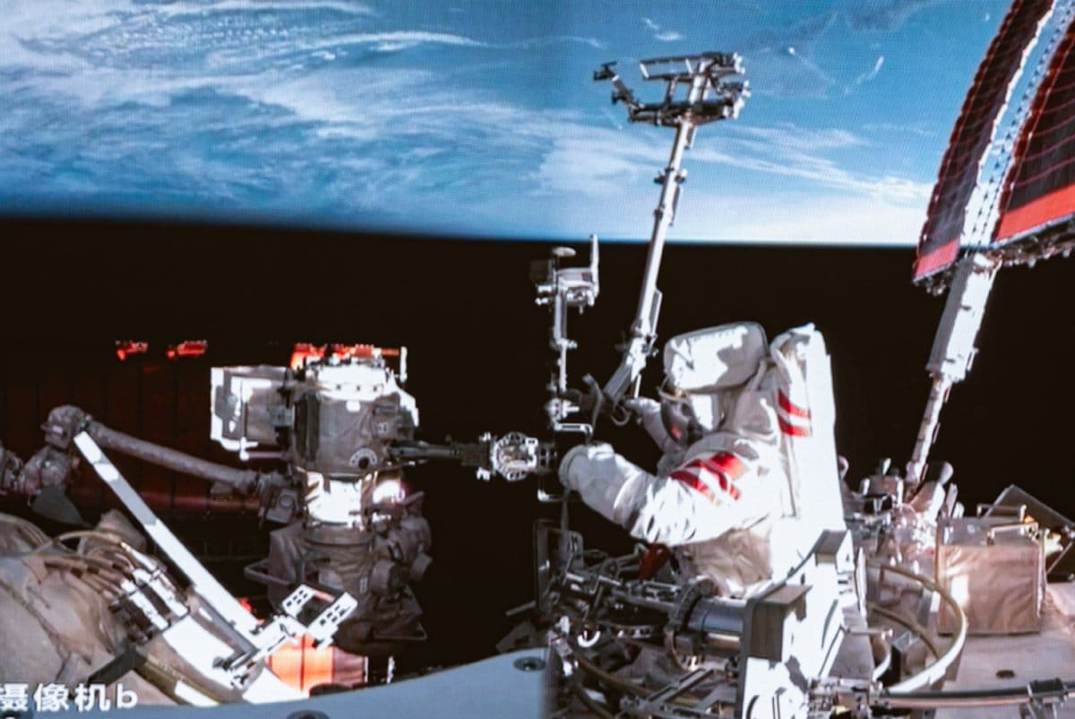 Cai Xuzhe preparing Tiangong's robotic arm for use during the spacewalk.
