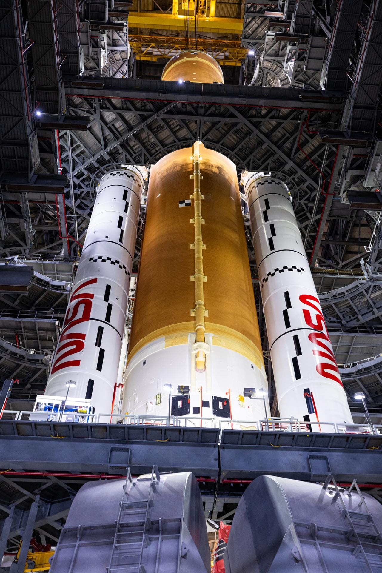 The core stage of SLS being placed between its two solid rocket boosters. ©NASA