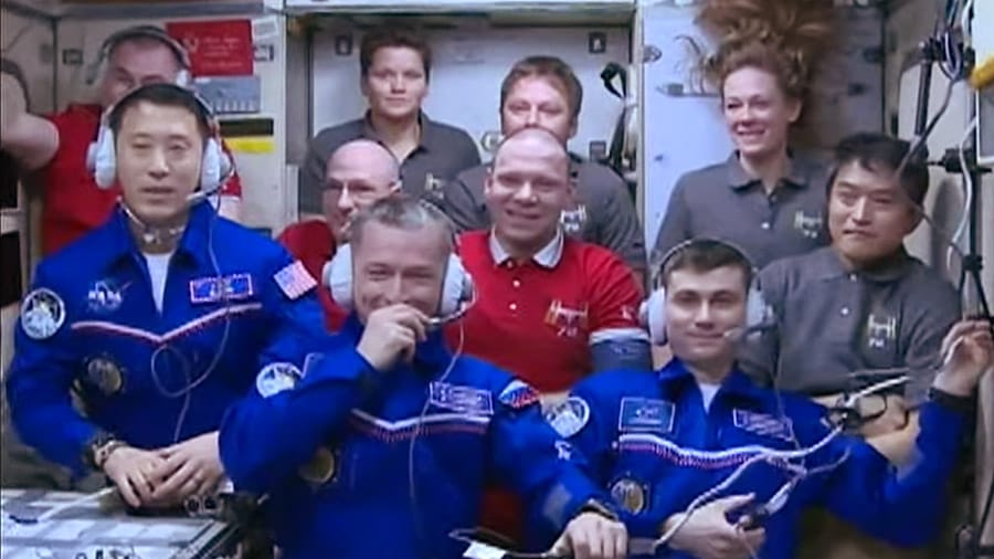 The MS-27 crew, Jonny Kim (left), Sergey Ryzhikov (center), and Alexey Zubritskoy (right), in the front row with the rest of the International Space Station's crew on April 8th. ©NASA