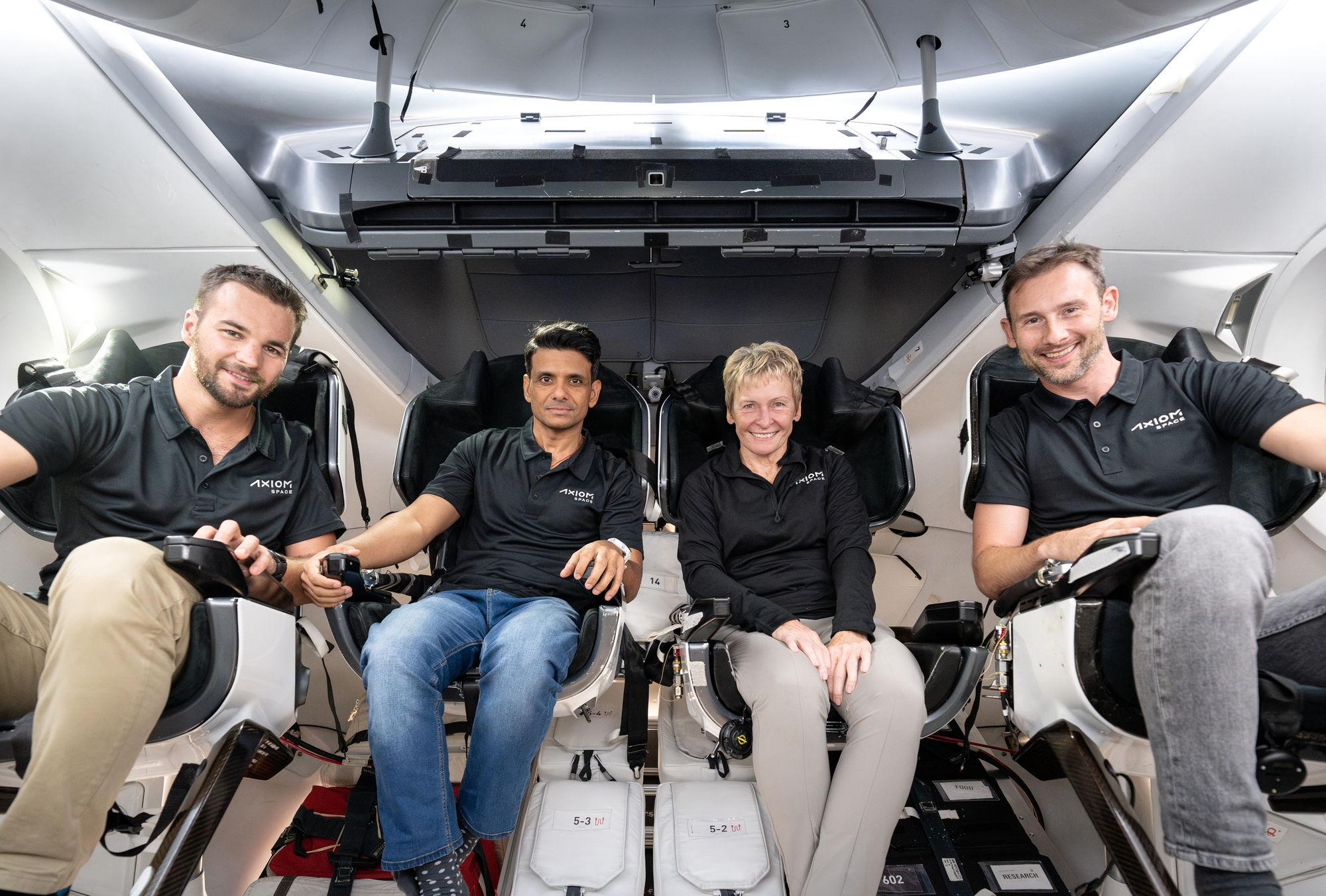 Tibor Kapu (left), Shubhanshu Shukla (center left), Peggy Whitson (center right), and Sławosz Uznański-Wiśniewski (right) inside Crew Dragon during training. ©SpaceX