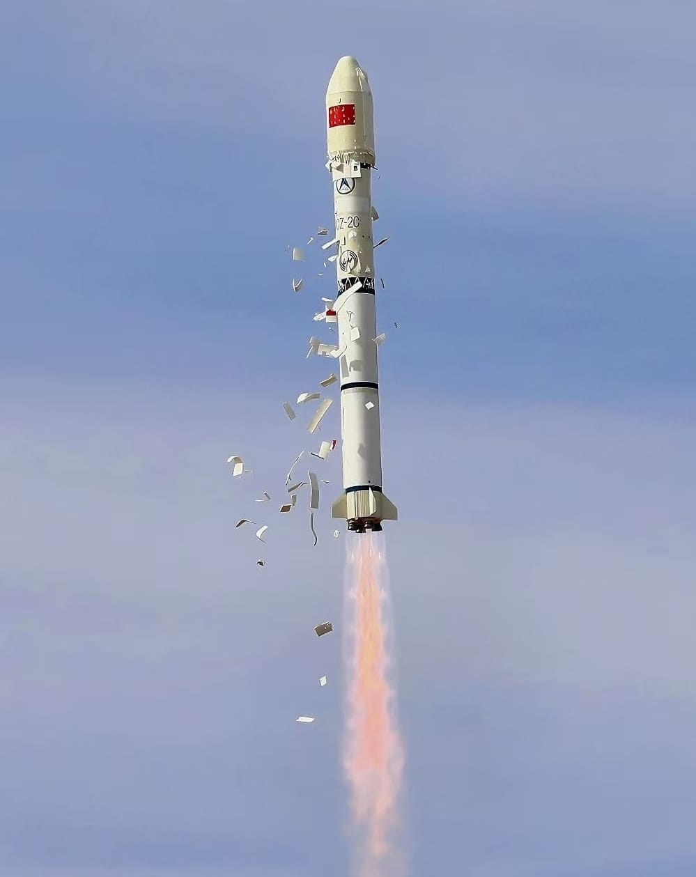 The Long March 2C launch vehicle during first-stage flight shedding pre-flight thermal insulation tiles on November 19th 2025.