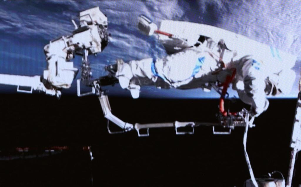 Wu Fei on the end of Tiangong's robotic arm to inspect the attachment point of a solar panel as part of a spacewalk on March 16th 2026.