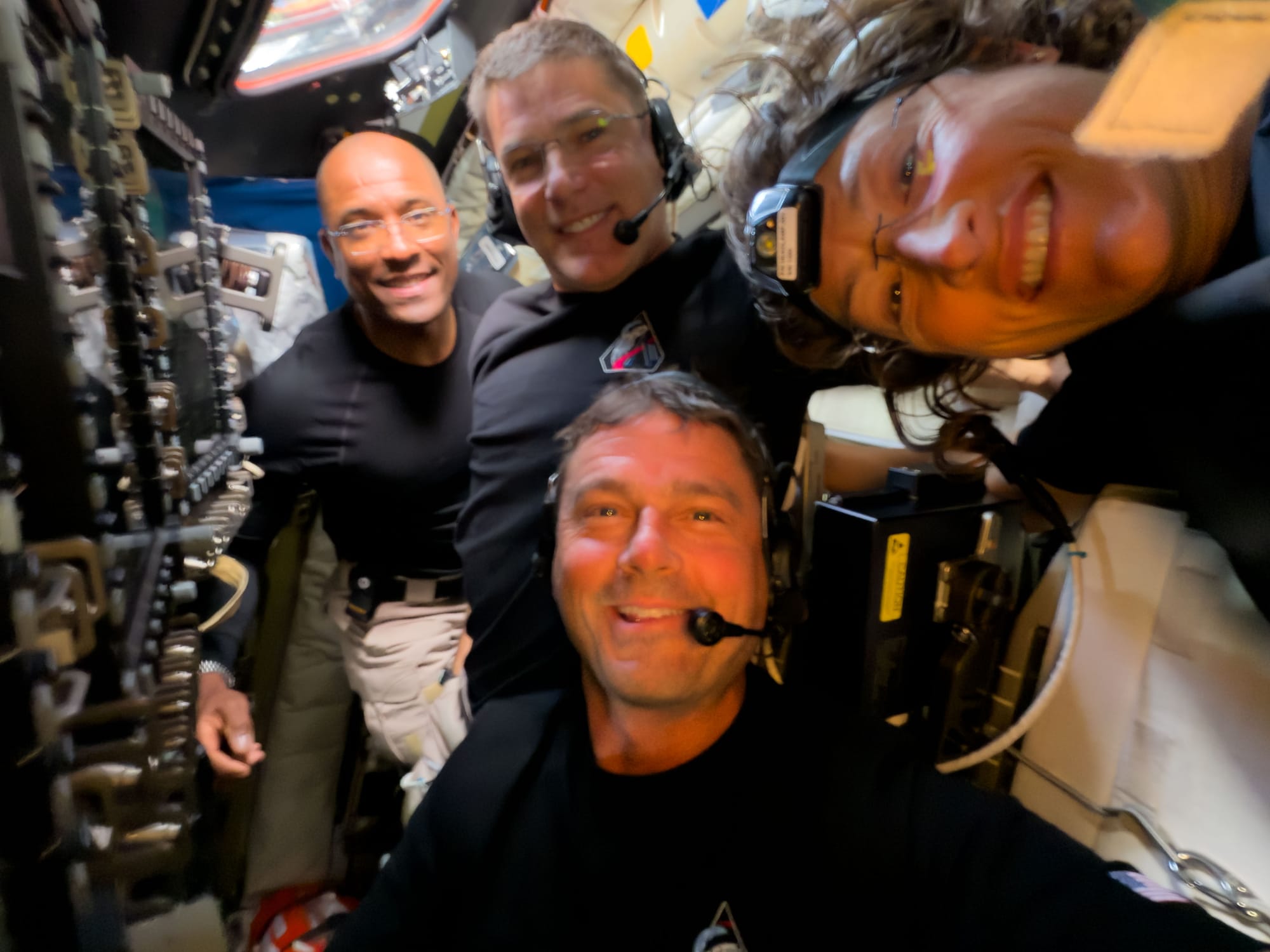 A selfie of the Artemis II crew during their lunar flyby on April 6th; Victor Glover (left), Jeremy Hansen (center top), Reid Wiseman (center bottom), and Christina Koch (right). ยฉNASA